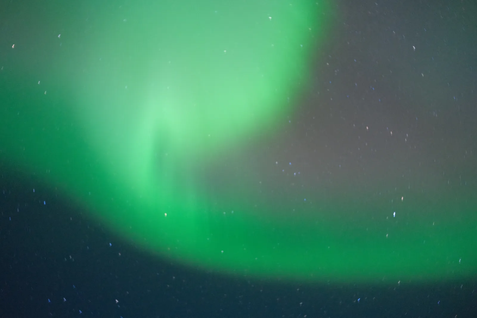 A display of the Northern Lights illuminates the night sky.